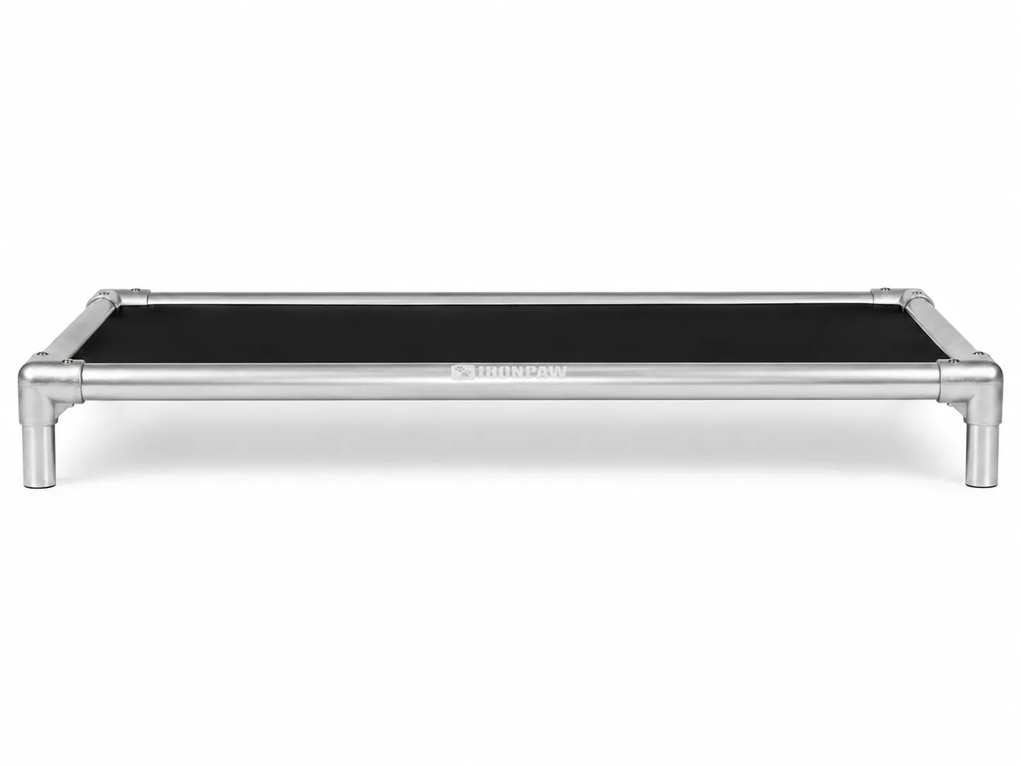 Minimalist side profile product photo of the IronPaw Steel elevated dog bed with glossy black PVC fabric, brushed silver aluminium frame, rounded corner connectors, bare tube legs, and pale laser-engraved logo centred on the long front rail against a white studio background.