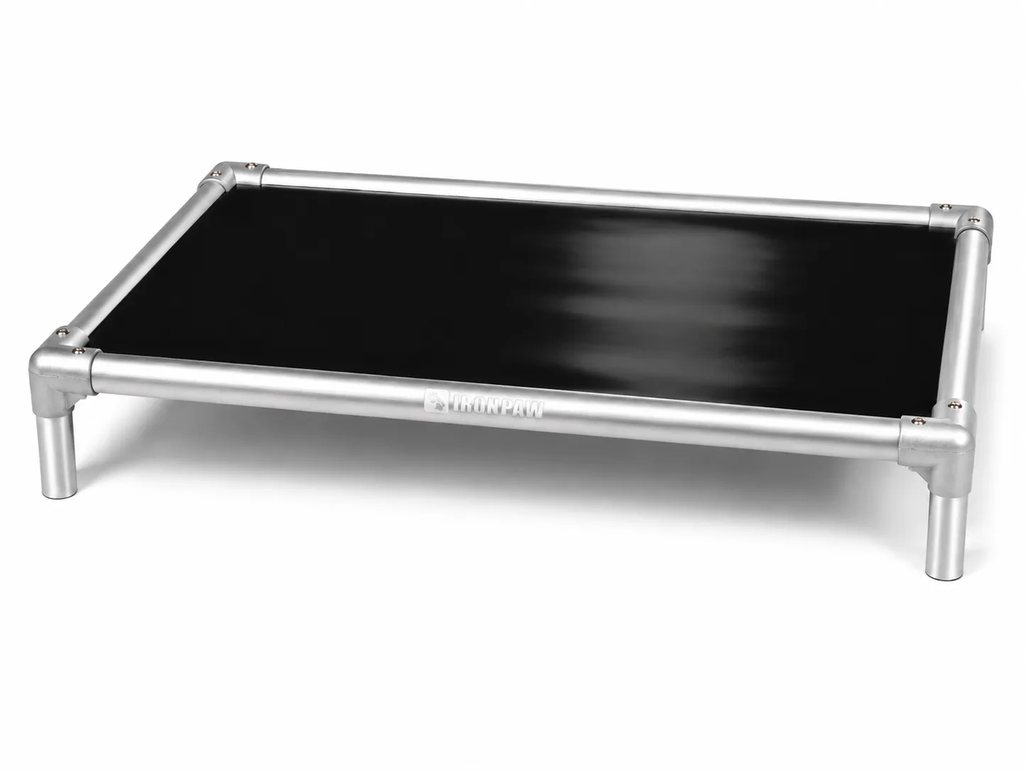 Commercial studio product photo of the IronPaw Steel elevated dog bed with glossy black PVC fabric, brushed silver aluminium frame, rounded corner connectors, bare tube legs, and pale laser-engraved IronPaw logo centred on the long front rail.